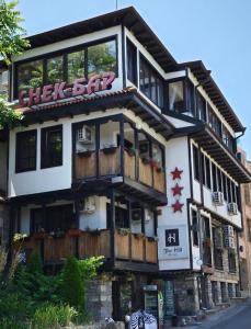 a building with a check bar sign on it at Hostel By the Hill in Veliko Tŭrnovo