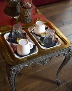 a coffee table with two plates and cups on it at Locanda Al Cappello in Udine
