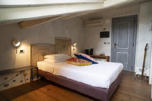 a bed with a basket on top of it in a room at Locanda Al Cappello in Udine +23 photos