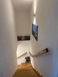 a staircase in a house with a picture on the wall at Ferienwohnung Theus in Albersdorf