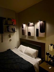 a bedroom with a bed and two mirrors on the wall at luxury house airport in Koropi