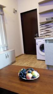 a bowl of fruit on a table in a kitchen at Apartment on Tabukashvili Street in Tbilisi City