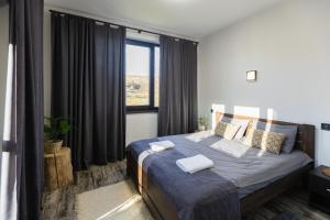 a bedroom with a bed with two towels on it at Shatiz in Izki