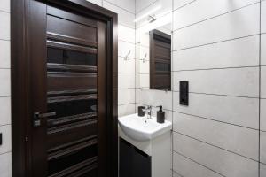 a bathroom with a sink and a wooden door at Shatiz in Izki +39 photos