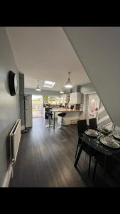 a kitchen and living room with a table and chairs at The house with a view in Warrington