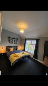 a bedroom with a large bed and a window at The house with a view in Warrington