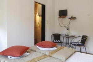 a bedroom with two red pillows on a bed at House Drakulić in Korenica
