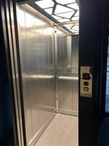 an elevator in a building with a metal wall at Bon Bon Luxury di piazza San Secondo in Asti