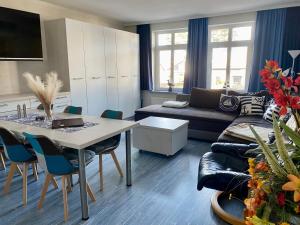 a living room with a table and a couch at Kieferneck Ferienwohnung Hedi in Karlshagen