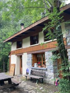 a stone house with a bench in front of it at Refuge-style chalet Mountain view in Colmars +22 photos