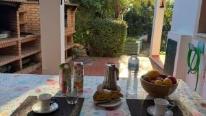 a table with a bowl of fruit and a bottle of water at CHESA RUISA in Castro Marim