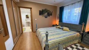 a bedroom with a bed and a window and a bathroom at CHESA RUISA in Castro Marim