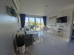 a living room with a couch and a table at The nice condo 2 BR at Karon in Karon Beach