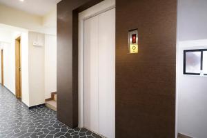 a hallway with a door with a sign on it at FabHotel Samrath in Mumbai