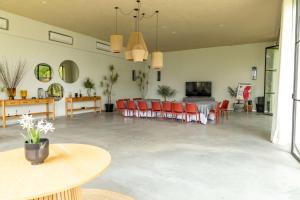 a large room with red chairs and a dining room at Soul Spring Sanctuary Cuernavaca, WorldHotels Luxury in Xochitepec