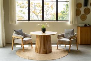 a table and two chairs and a table with a vase on it at Soul Spring Sanctuary Cuernavaca, WorldHotels Luxury in Xochitepec