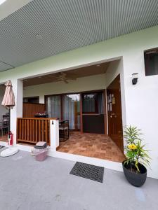 a house with a porch with a patio at Sonnenblume Homestay in General Luna