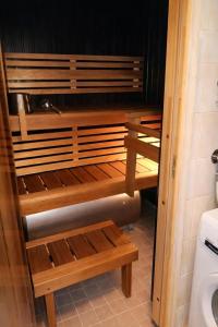a bathroom with wooden shelves and a toilet at Northern Lights Lodge in Kittilä +14 photos