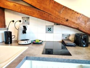 a kitchen with a counter top with a stove top oven at Le studio du centre in Gap