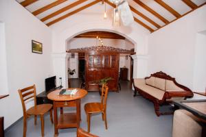 a living room with a table and chairs and a couch at Cinnamon Legacy in Weligama