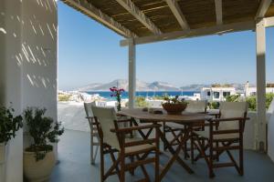 a table and chairs on a patio with a view of the ocean at Anna's House in Koufonisia