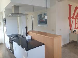 a kitchen with a counter top and a stove at Guesthouse Thibault in Gistel