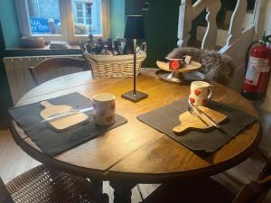 a wooden table with utensils on top of it at Chassepierre's Soul in Chassepierre
