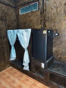 a room with a tv and curtains on a wall at The love shack atChaba in Ko Lanta