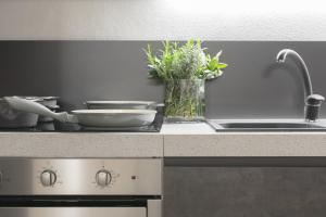 a kitchen with a counter with a sink and a stove at Suite del Pirata in Gargnano +8 photos