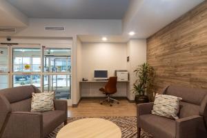 an office with two chairs and a desk with a computer at Candlewood Suites New Bern by IHG in New Bern