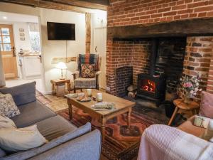 a living room with a couch and a fireplace at The Old Post Box in Holton