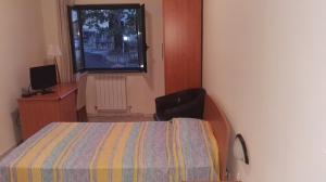 a small bedroom with a bed and a window at Raggio di Sole in Rende