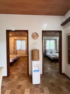 a room with two beds and a refrigerator in it at Sonnenblume Homestay in General Luna