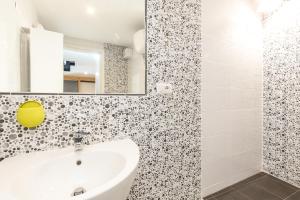 a bathroom with a sink and a mirror at Casa Ale in centro in Santa Maria Navarrese +35 photos