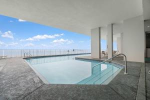a swimming pool with a view of the ocean at Windemere 1003 in Perdido Key
