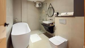 a white bathroom with a toilet and a sink at Royal Avenue Kandy in Kandy +31 photos