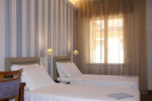 
A bed or beds in a room at Hotel San Donato - Bologna centro

