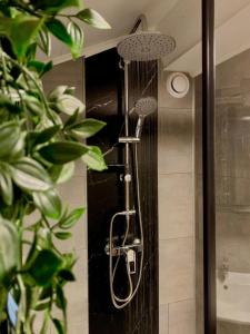 a shower with a shower head in a bathroom at Chalet Het Hulstje 2 in Durbuy