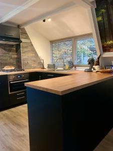 a kitchen with a sink and a counter top at Chalet Het Hulstje 2 in Durbuy +33 photos