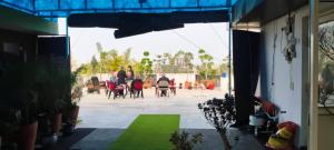 a group of people sitting at a table in a patio at C T Heights Inn in Bharatpur