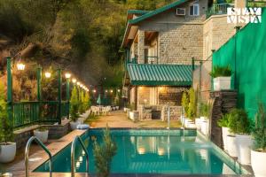 a swimming pool in front of a building at StayVista at Villa Montierra with Luxury Pool Villa & Complimentary Breakfast in Kasauli