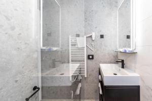 a bathroom with a shower and a sink and a tub at Holiday Resort Ad Turres in Crikvenica