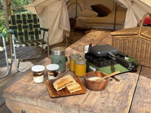 a table with bread and jam on it with a mixer at The Lodge Okinawa in Nakijin +42 photos