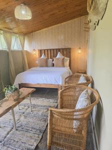 a bedroom with a bed and a table and chairs at Rustique in Graskop +20 photos