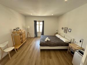 a bedroom with a large bed and a wooden floor at Larios Rooms in Málaga