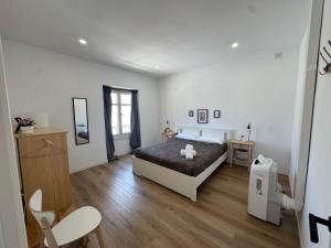 a bedroom with a bed and a wooden floor at Larios Rooms in Málaga