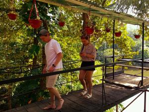 a man and a woman standing on a walkway at Riverview Adventure Resort in Kitulgala