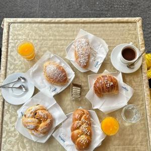 a table topped with pastries and a cup of coffee at Alma Adry in Naples