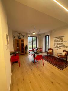 a living room with a table and red chairs at Countryhouse Verso in Rovereto +25 photos