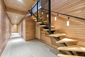 a hallway with wooden walls and stairs in a house at Villa Solarsuite Incl WiFi, Jacuzzi for extra fee in Himos